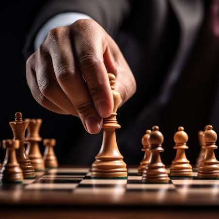 Hand moving a piece on a chessboard
